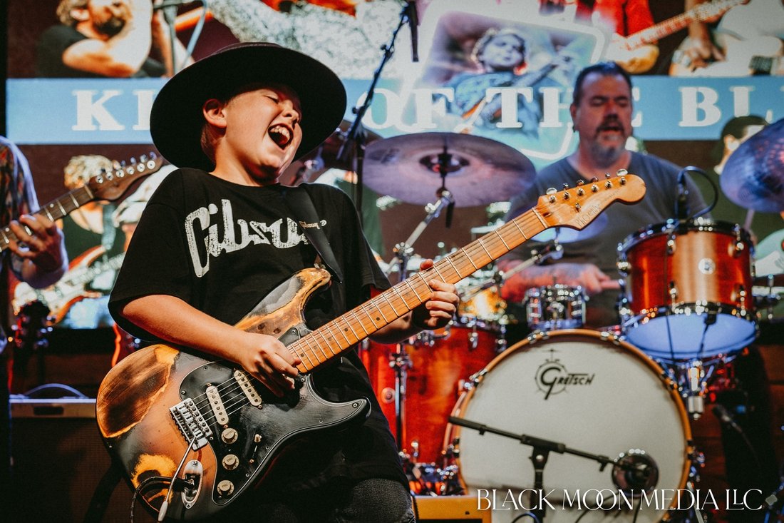Emmitt DeWater playing guitar on stage